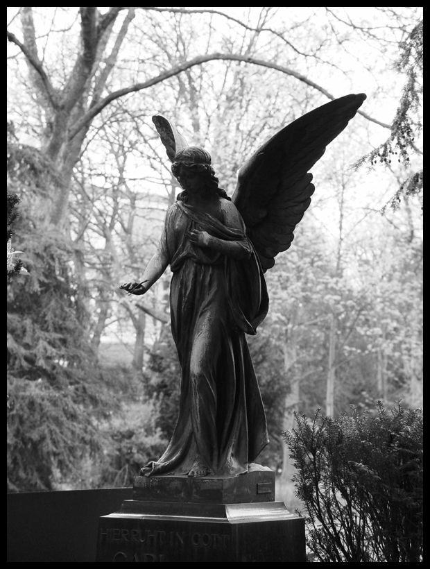 an angel statue is shown in black and white