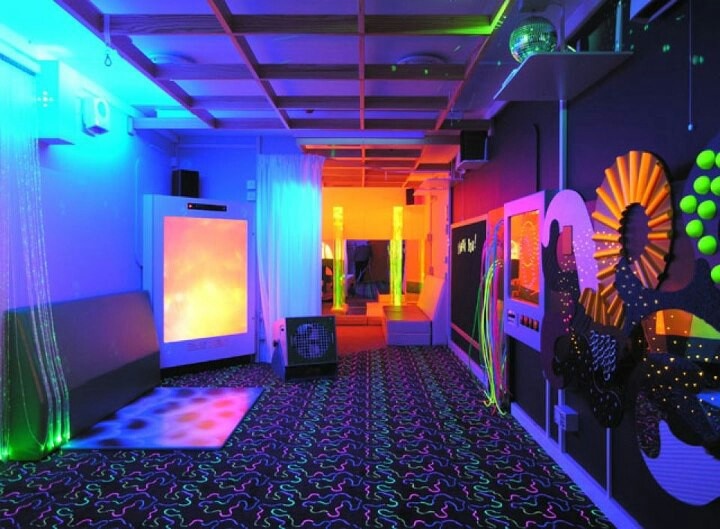 an empty room with neon lights and decorations