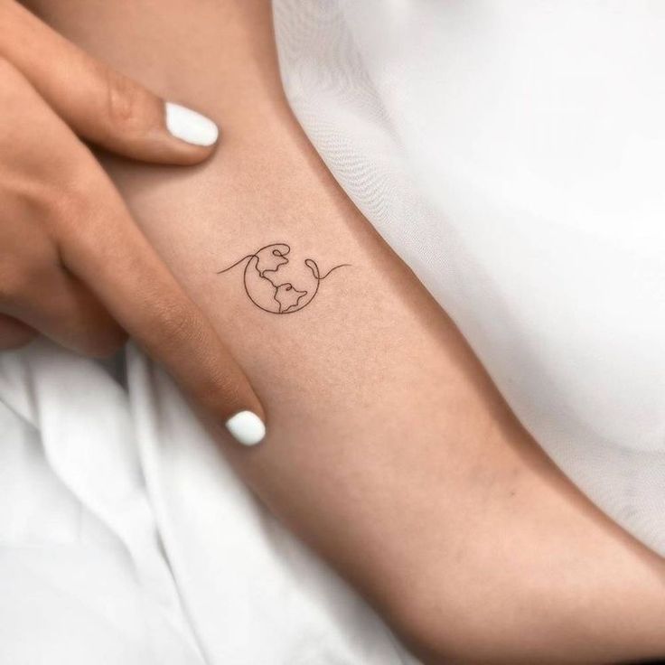 a woman's arm with a small tattoo on the left side of her arm