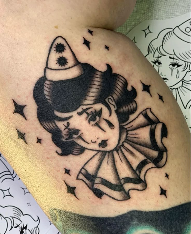 a woman with a hat on her head and stars around her neck is depicted in this tattoo design