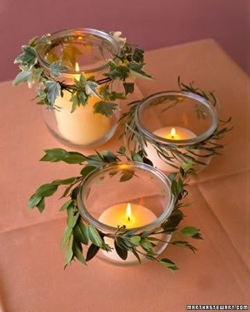 three glass jars filled with candles sitting on top of a table