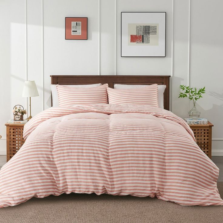 a bed with pink and white striped comforter