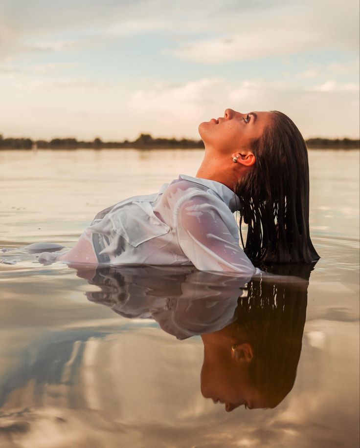 a woman floating on top of a body of water