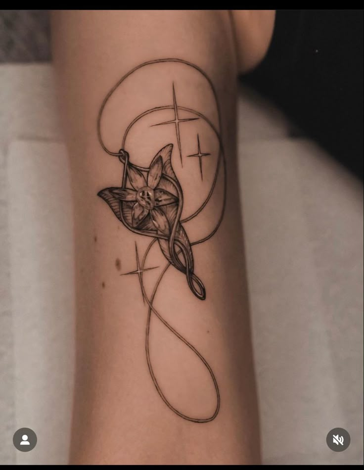 a cat tattoo on the leg of a woman's left arm, with lines and circles around it