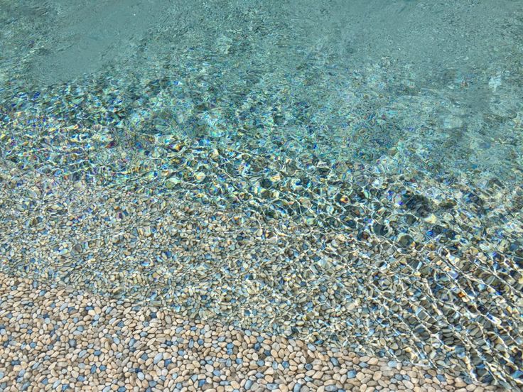 the water is crystal blue and clear with little bubbles in it's bottom half