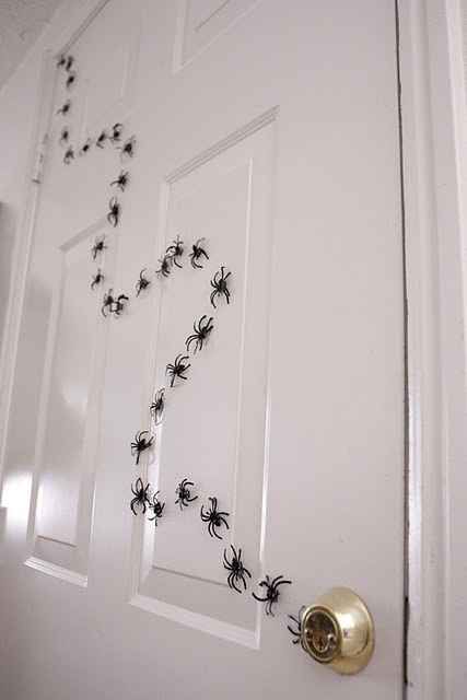 the door is decorated with black spider webs