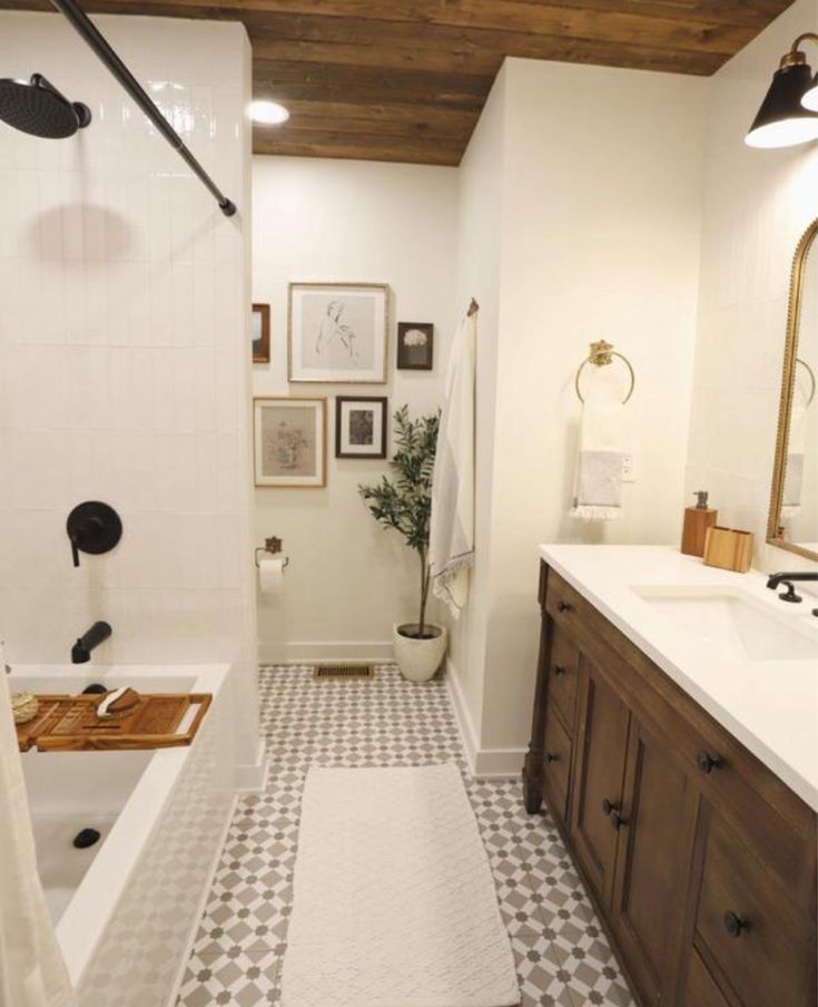 a bathroom with a bathtub, sink, and shower in it's center