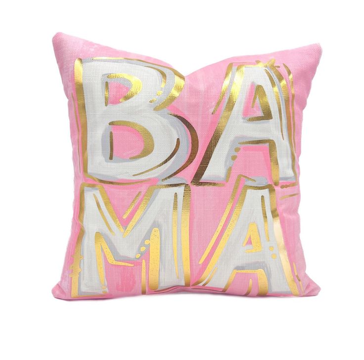 a pink and gold pillow with the word ba ma on it