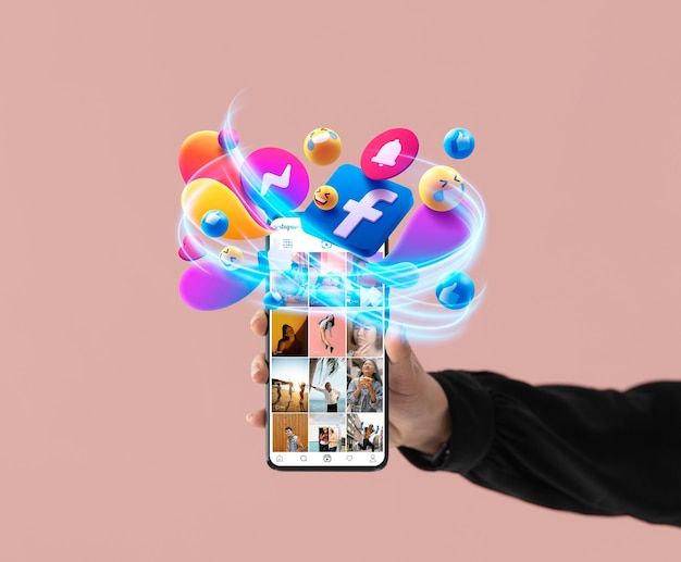 a person holding up a smart phone with social media icons coming out of the screen