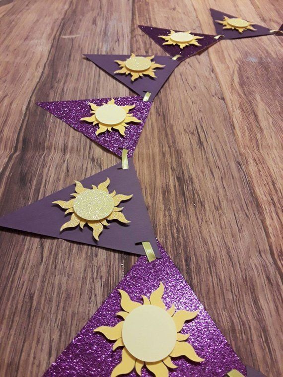 purple and gold paper with sun cutouts on it