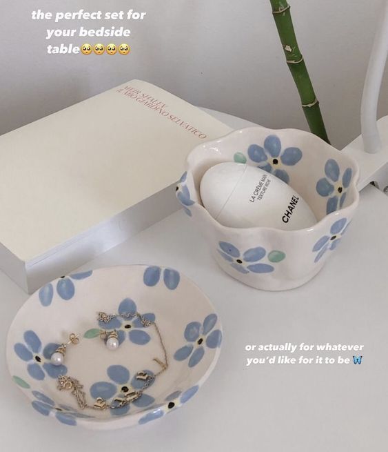 a blue and white flowered bowl next to a plate with a ring on it