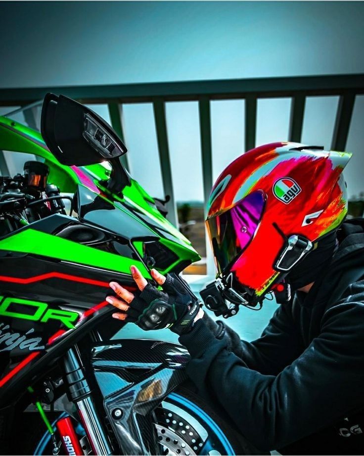 a person wearing a helmet sitting on a motorcycle