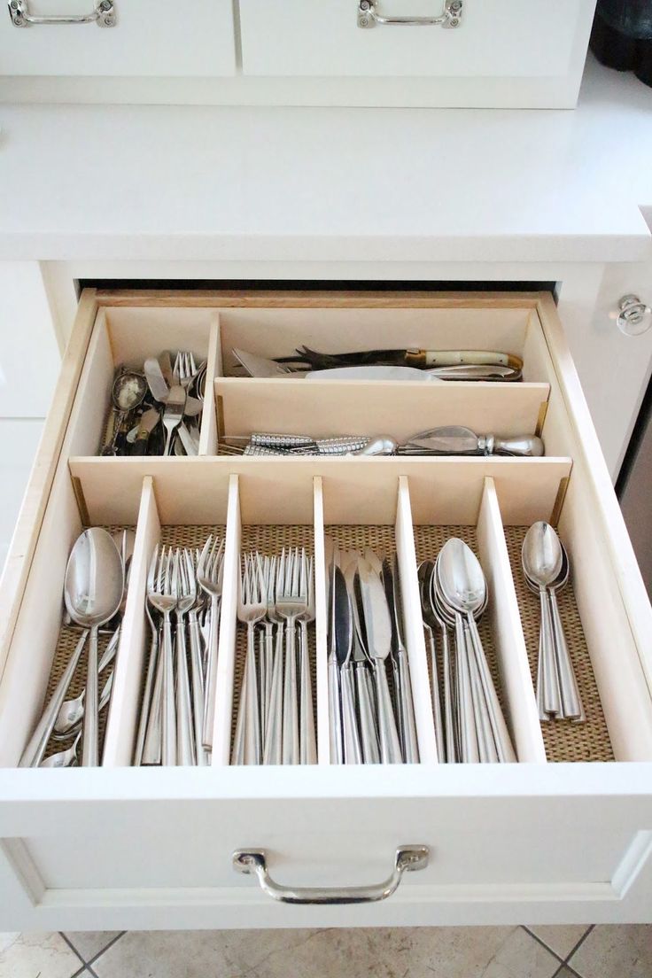 an open drawer with silverware in it