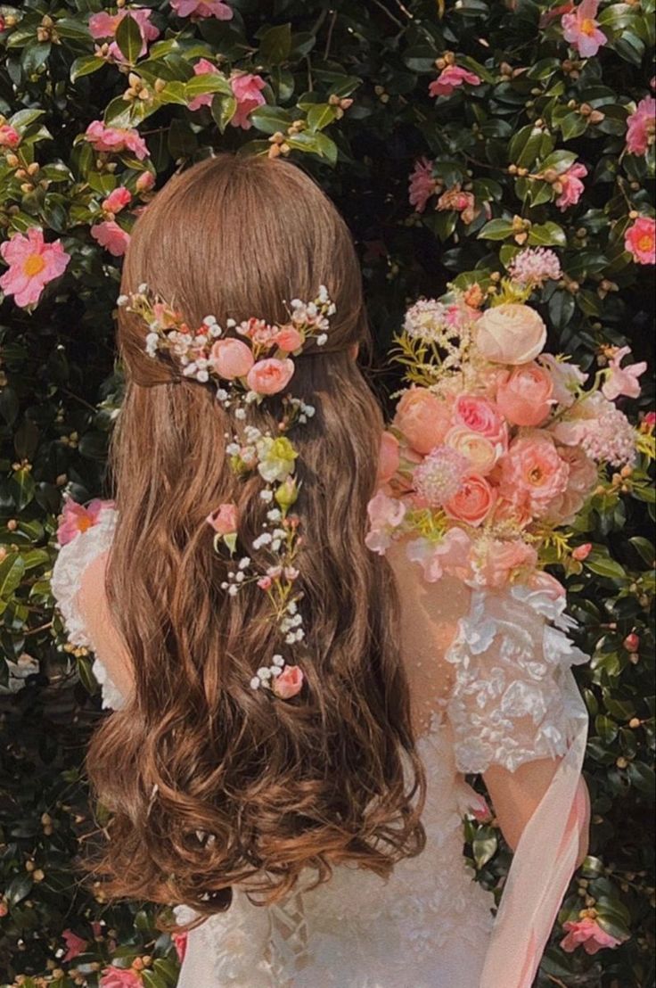 a woman with long hair and flowers in her hair