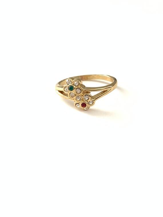 Vintage Dainty Red Green Clear Rhinestone Crystal Flower Ring, Vintage Gold Tone Flower Stacking RingSweet dainty new old stock flower rings, in very good vintage condition. All items such as boxes, coins, etc., in photos are NOT included with the jewelry, they are props being used for display. Important: Please read all shop policies prior to purchase.The below is a brief overview, to view full shop policies please go to the homepage of the shop and scroll to the bottom and they are listed in f Vintage Multi-stone Birthstone Ring As Gift, Vintage Flower-shaped Multi-stone Jewelry, Vintage Gold Jeweled Rings, Vintage Jeweled Rings, Vintage Red Flower Ring For Wedding, Vintage Cluster Ring With Birthstone For Gift, Vintage Multi-stone Birthstone Promise Ring, Vintage Birthstone Cluster Ring As A Gift, Vintage Flower Anniversary Ring