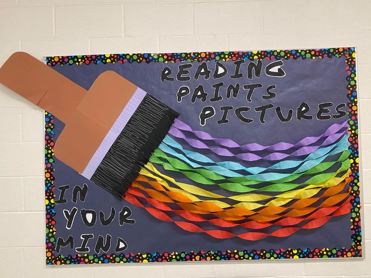 a bulletin board with a paint brush on it that says reading paints pictures in your mind