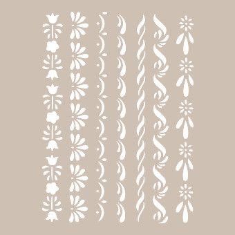 the stencil set is designed to look like flowers and swirls in white on a light gray background