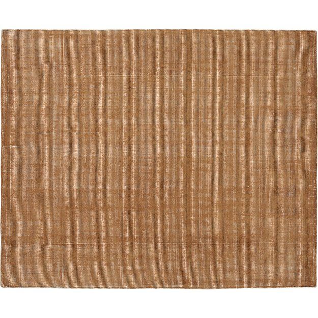 an area rug with a brown color on the bottom and tan colored flooring in the middle