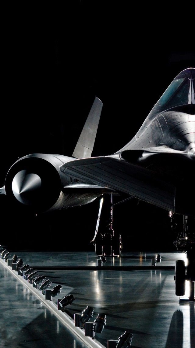 an airplane sitting on top of a runway at night