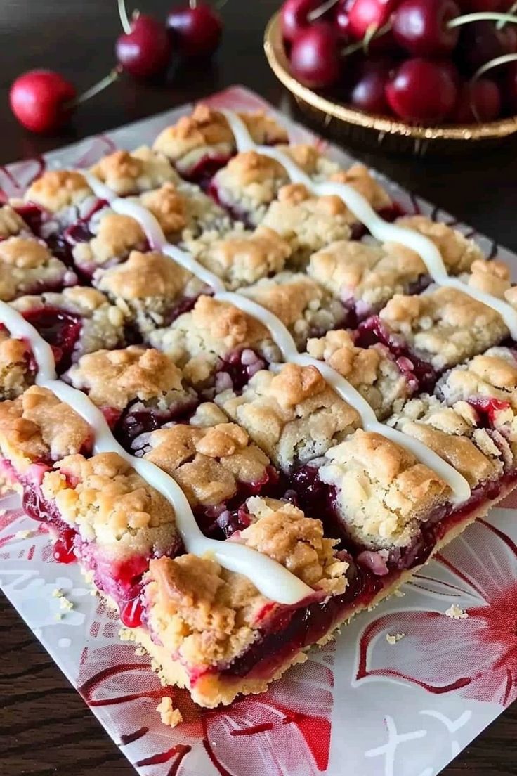 a close up of a dessert on a plate with cherries