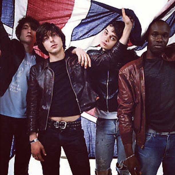 group of young men standing next to each other in front of an union jack flag