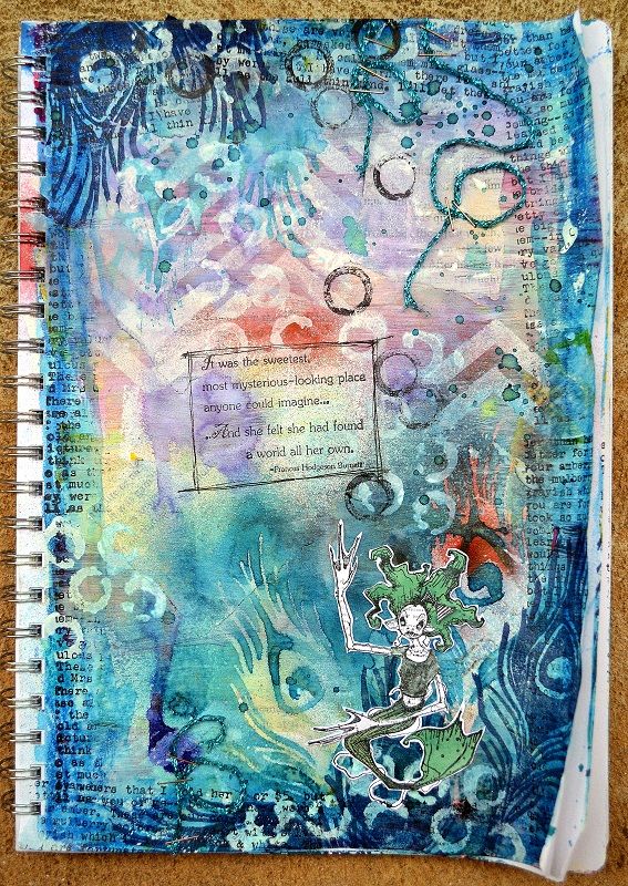 an art journal with watercolors and ink on paper, featuring a drawing of a mermaid