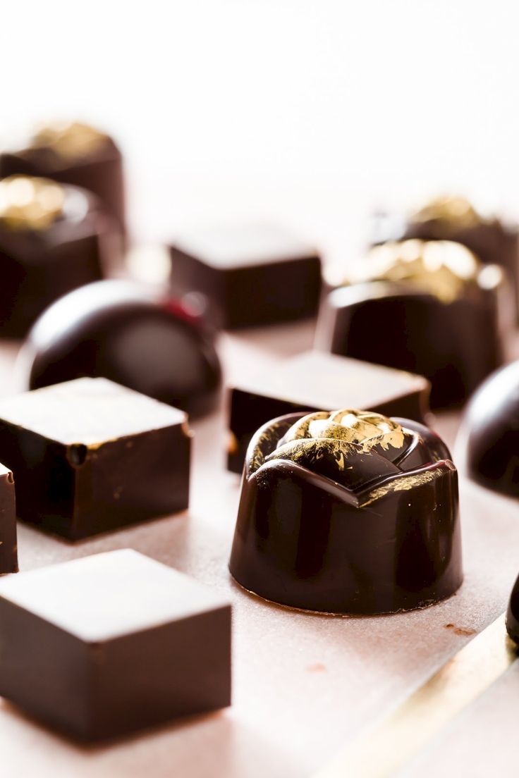 some chocolates are sitting on a table next to a knife