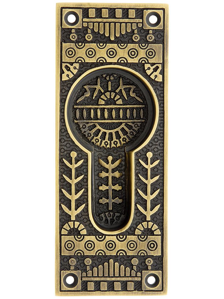 an antique style door handle with decorative designs on the front and back panel, in gold