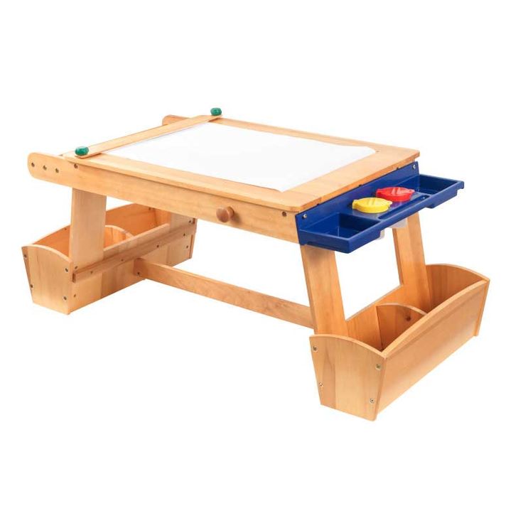 a child's wooden table with two bins underneath it