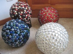 four different colored balls sitting on the floor