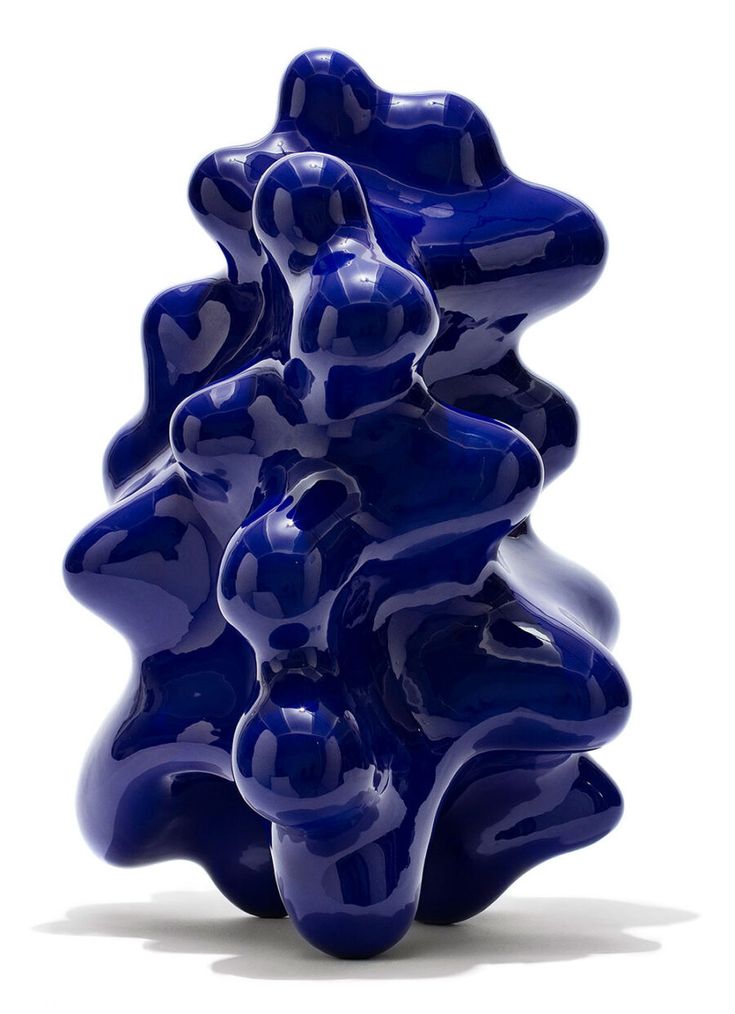 a blue sculpture sitting on top of a white floor