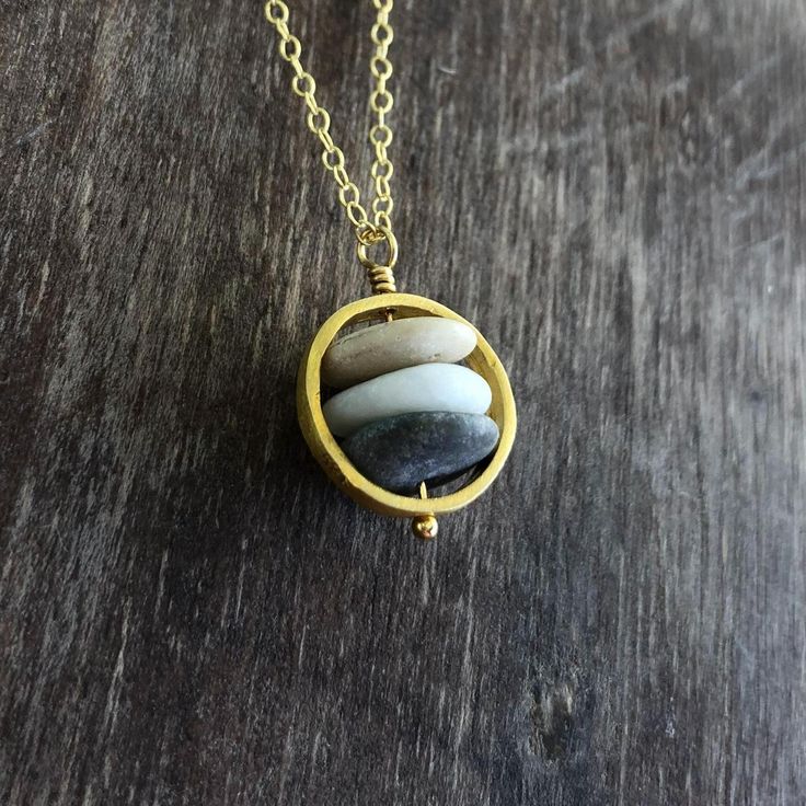 Have the beauty of nature on you with this beach stone necklace. Delicate but strong, symbolizing the inner strength, just like the power of the rocks. This necklace is created with a variety of hand picked stones from greek beaches. The necklace is created in high quality 24K gold plated sterling silver. The circle is approx. 14 mm / 0.55". Each necklace is unique, like the beautiful pebbles that it is created with. The beach pebbles have the colours of earth, white, black, gray, brown, beige. Cairn Necklace, Stacked Stones, Beach Stones Jewelry, Greek Beaches, Pebble Pendant, Pebble Necklace, Raw Stone Necklace, Beach Pebbles, Rock Necklace