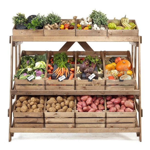 an assortment of fruits and vegetables displayed in wooden crates with price tags on the sides