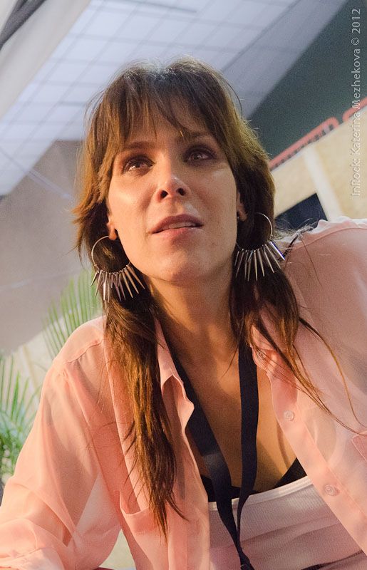 a woman wearing large earrings sitting down