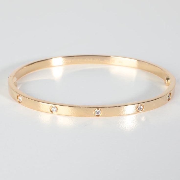 Cartier Love Bracelet, 10 Diamond (Yellow Gold)  PRIMARY DETAILS  SKU: 139971  Listing Title: Cartier Love Bracelet, 10 Diamond (Yellow Gold)  Condition Description: Cartier's Love collection is the epitome of iconic, from the recognizable designs to the history behind the line-up. The collection started in 1969 with the bangle bracelet, which is engraved with a circular motif throughout to mimic the look of the bracelet's signature screw-lock mechanism.     Retails for 9500 USD. In excellent condition and recently polished. 17 cm in length. Comes with Box;Certificate of Authenticity;Screwdriver;Original Receipt;  Brand: Cartier  Collection/Series: Love  Metal Type: Yellow Gold  Metal Purity: 18k  Chain or Bracelet Length (in): 17  Pre-Owned Jewelry Condition: Excellent  SIDE STONE INFORMA Cartier Love Collection, Modern Bangle, 18k Gold Bangle, Contemporary Bracelets, Plastic Bangles, Resin Bangles, Enamel Bangle, Crystal Bangle, Love Bracelet