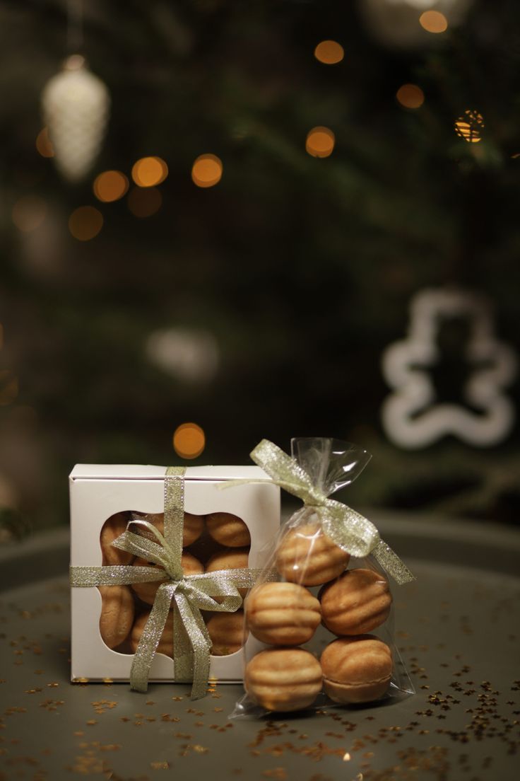 a white box filled with almonds next to a christmas ornament and tree