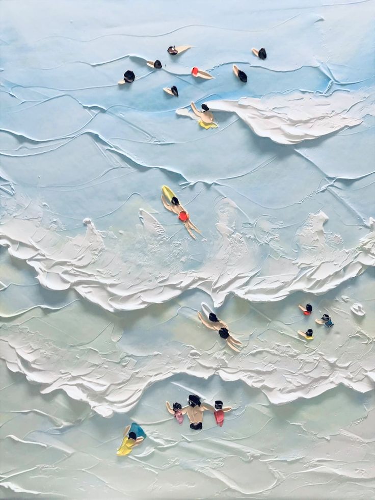 an aerial view of people swimming in the ocean with surfboards on their backs and feet