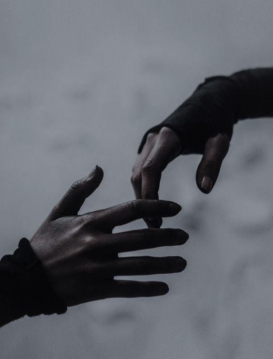 two hands reaching out towards each other