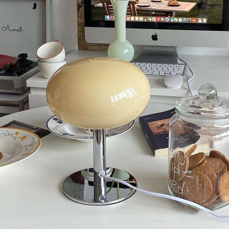 a desk with a computer and some cookies on it