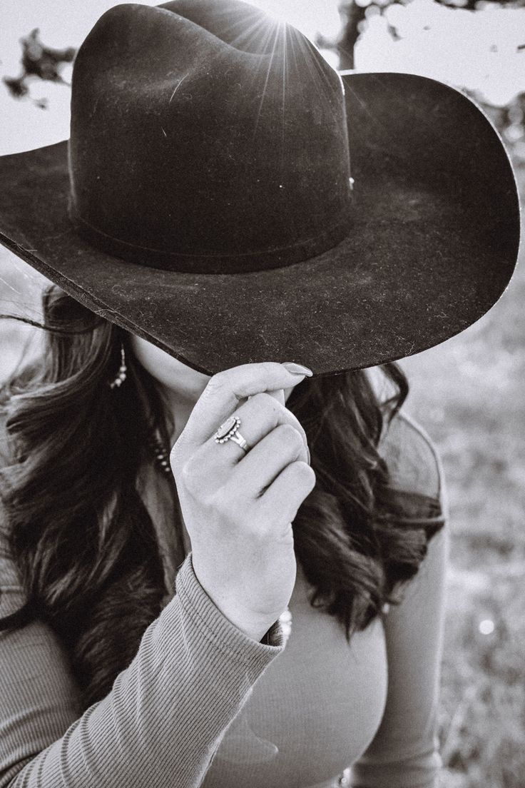 black and white photograph of a woman wearing a cowboy hat