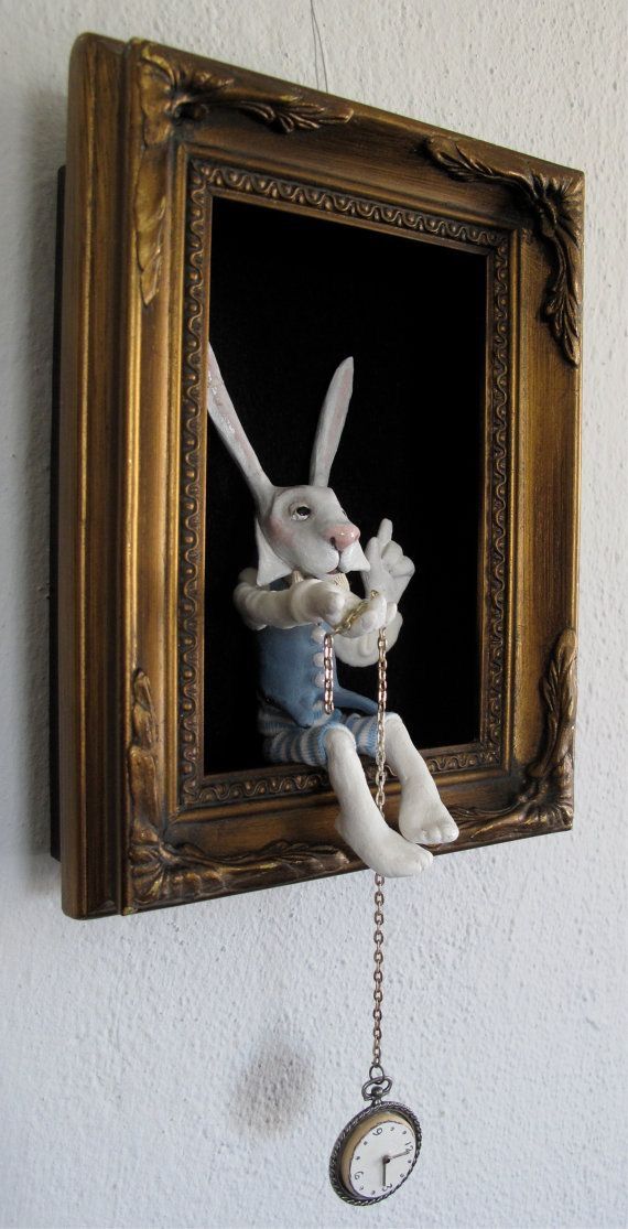 a white stuffed animal hanging from a wall with a clock on it's side