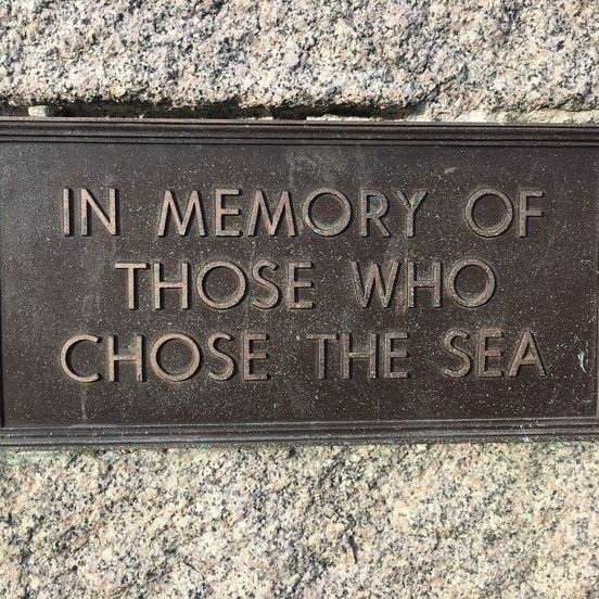 a plaque that reads in memory of those who chose the sea