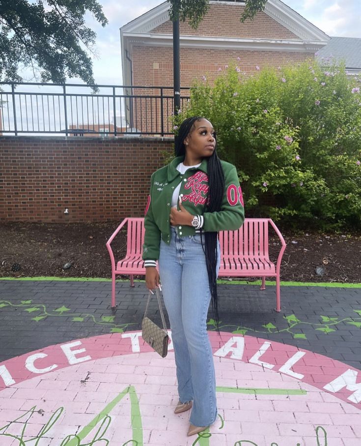 a woman standing in front of a pink bench