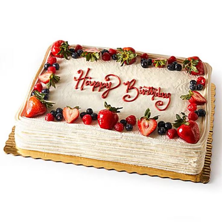 a birthday cake with strawberries and berries on it