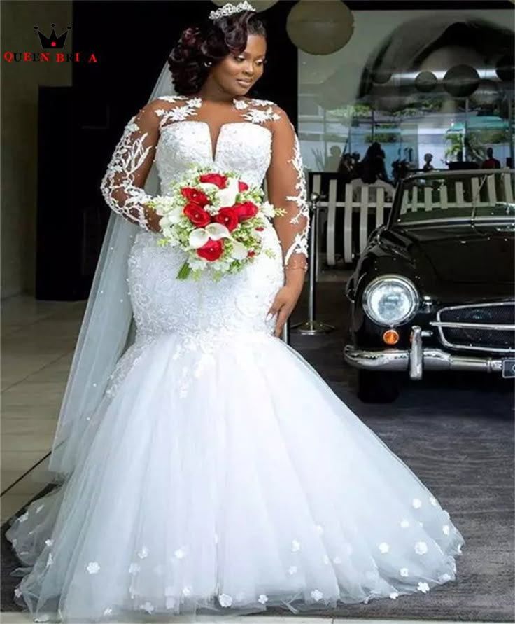 a woman standing in front of a car wearing a wedding dress with flowers on it