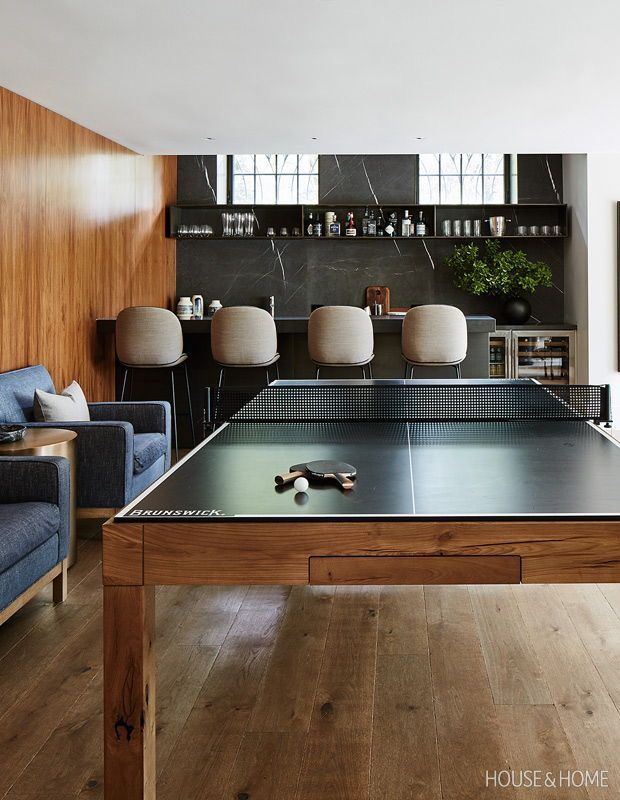 a ping pong table in the middle of a living room