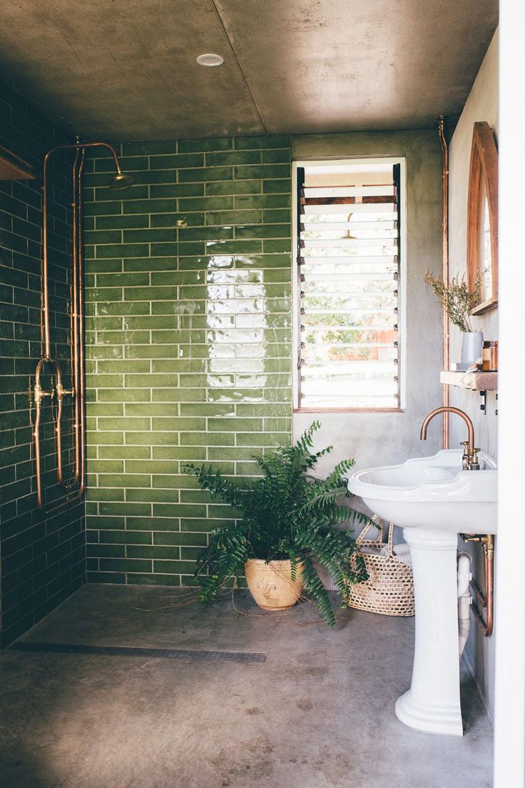 the instagram page shows an image of a bathroom with green tiles