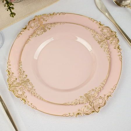 a pink and gold plate sitting on top of a table next to utensils