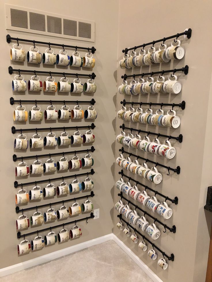 the wall is filled with coffee cups and mugs