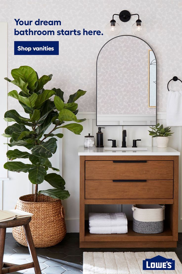 a bathroom with a mirror, sink and plants